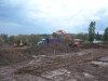 Topsoil,stripped from the new parking area, is being loaded out to be stock piled.